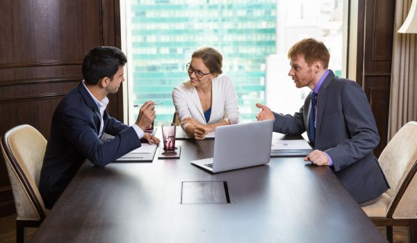 three business professionals discussing a project